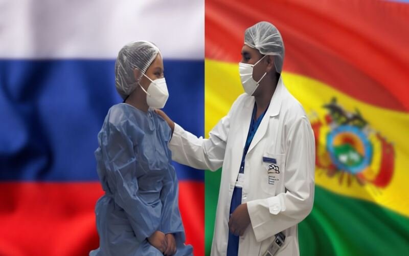 Médico y paciente en el Centro de Medicina Nuclear de la ABEN con las banderas de Bolivia y Rusia de fondo