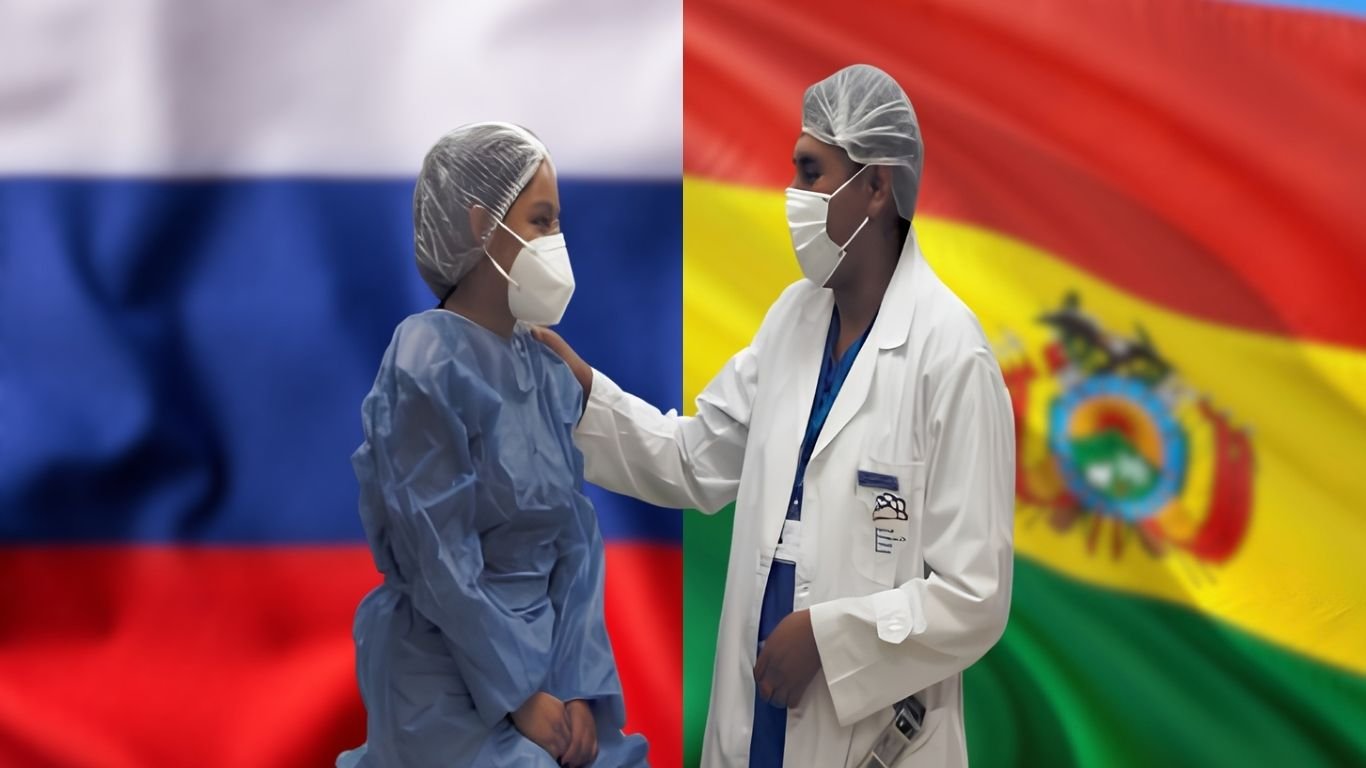 Médico y paciente en el Centro de Medicina Nuclear de la ABEN con las banderas de Bolivia y Rusia de fondo